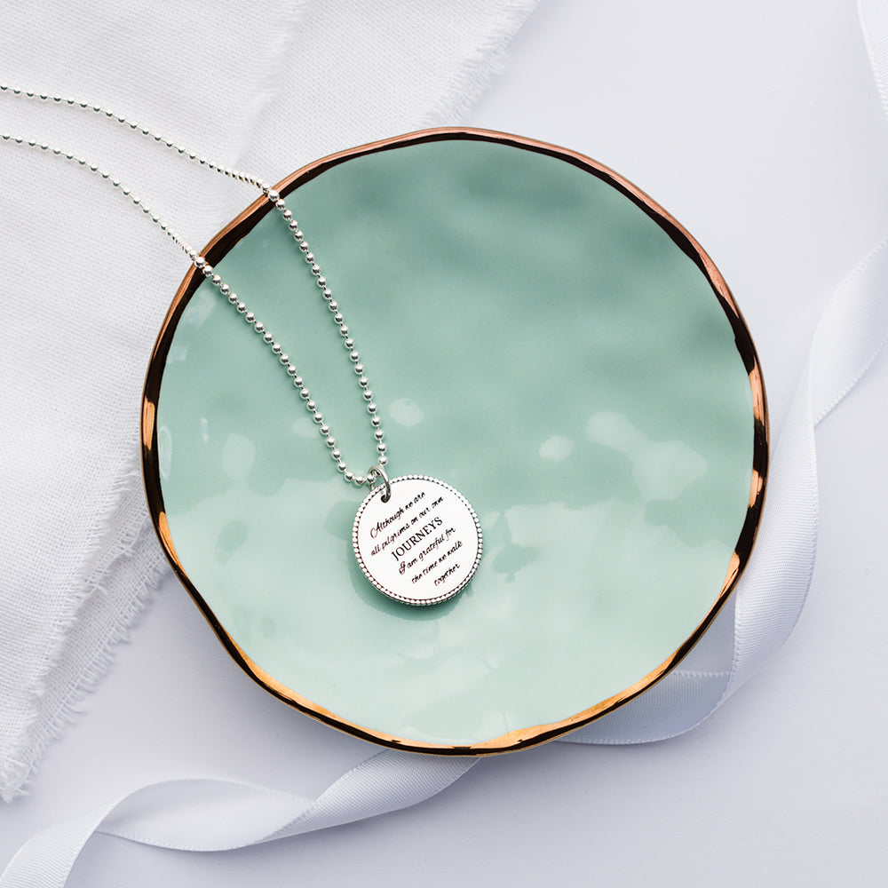 Pilgrim necklace jewellery on a green plate