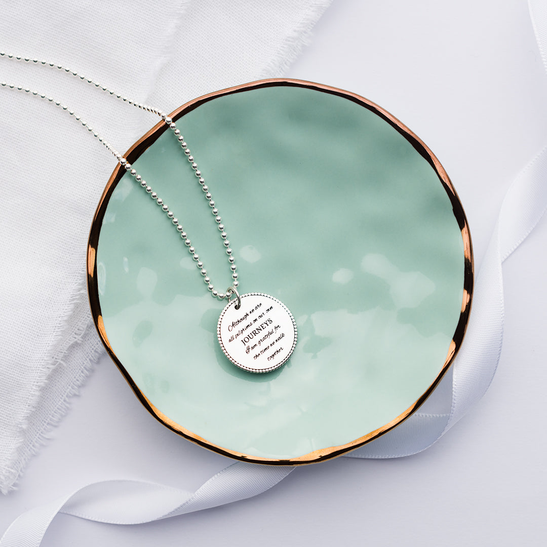 Pilgrim necklace jewellery on a green plate