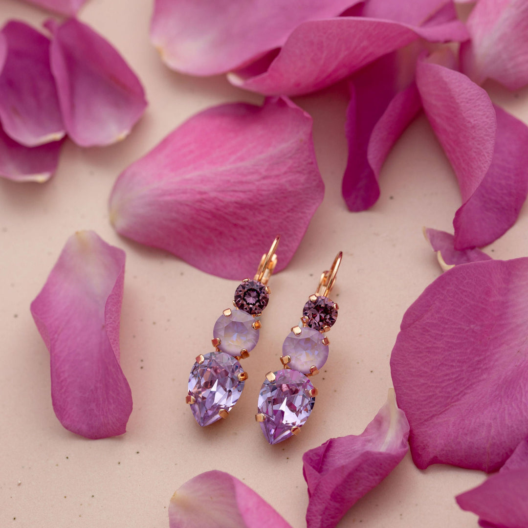 Purple crystal earrings on pink rose petals