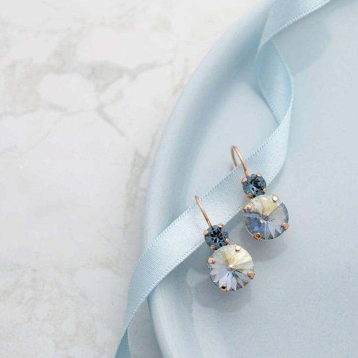 Earrings with blue crystals on a light blue ribbon and plate
